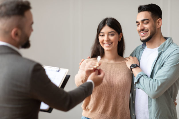 Real Estate Agent Giving Keys To Buyers real estate agent